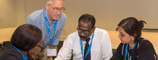 Facilitator with delegates at a conference